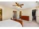 Spacious bedroom with a ceiling fan, double closets, and multiple doorways at 101 Rustic Wood Ln, Cary, NC 27518