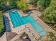 A refreshing community pool offers lap lanes and a leisure area, surrounded by lounge chairs and lush landscaping at 101 Rustic Wood Ln, Cary, NC 27518