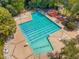 Large community pool with ample lounge seating and a playful slide surrounded by lush greenery at 101 Rustic Wood Ln, Cary, NC 27518