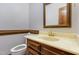 A traditional powder room featuring a decorative mirror and wooden vanity at 101 Rustic Wood Ln, Cary, NC 27518