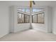 Bedroom features a ceiling fan and large windows at 1011 Oxbow Crossing Rd, Chapel Hill, NC 27516