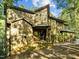 Charming wooden home with large windows and covered front porch amidst lush greenery at 1011 Oxbow Crossing Rd, Chapel Hill, NC 27516