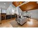 Spacious living room featuring a fireplace, hardwood floors, and large windows with wood accents at 1011 Oxbow Crossing Rd, Chapel Hill, NC 27516