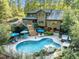 Aerial view of backyard with pool, patio, lounge chairs, and lush landscaping at 1011 Oxbow Crossing Rd, Chapel Hill, NC 27516