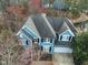 Aerial view of a blue home with gray roof and surrounding mature trees at 104 Deep Gap Run, Cary, NC 27519