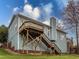 Backyard of blue house with a wooden deck and stairs at 104 Deep Gap Run, Cary, NC 27519