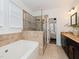 Bathroom with a glass-door shower, soaking tub, and dark cabinets at 104 Deep Gap Run, Cary, NC 27519