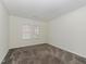 Bright bedroom featuring neutral walls, two windows and neutral carpet at 104 Deep Gap Run, Cary, NC 27519