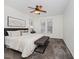 Cozy bedroom with carpet flooring, ceiling fan, and two windows for natural light at 104 Deep Gap Run, Cary, NC 27519