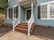 Charming front entrance with brick steps and white railing at 104 Deep Gap Run, Cary, NC 27519