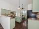 Bright kitchen featuring light green cabinetry, stainless steel appliances, and ample counter space at 104 Deep Gap Run, Cary, NC 27519