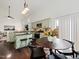 Open kitchen with vaulted ceilings, granite countertops, and a breakfast table set for four at 104 Deep Gap Run, Cary, NC 27519