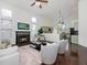 Bright living room with a fireplace, ceiling fan, and view into the kitchen at 104 Deep Gap Run, Cary, NC 27519