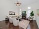 Bright living room with a fireplace, ceiling fan, and lots of natural light at 104 Deep Gap Run, Cary, NC 27519