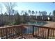 Scenic backyard pond view from wood deck with railing, offering a tranquil outdoor living experience at 104 Deep Gap Run, Cary, NC 27519