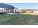 Large, grassy backyard with a patio, screened porch, and a playground set, ideal for Gathering activities at 107 Crescent Hill Ln, Rougemont, NC 27572