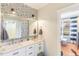 Bright bathroom with a double vanity, designer wallpaper, and black hardware at 107 Crescent Hill Ln, Rougemont, NC 27572