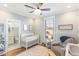 Cozy Bedroom with a crib, rocking chair, and attached bathroom at 107 Crescent Hill Ln, Rougemont, NC 27572