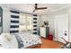 Charming bedroom with natural light, a ceiling fan, and nautical striped curtains at 107 Crescent Hill Ln, Rougemont, NC 27572
