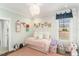 Cute bedroom with a trundle bed, playful wallpaper, and colorful decor at 107 Crescent Hill Ln, Rougemont, NC 27572