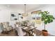 Elegant dining room with wainscoting, a chandelier, and views of the outdoor landscape at 107 Crescent Hill Ln, Rougemont, NC 27572