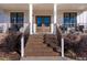 Inviting front porch with a brick staircase, modern railing, and a double front door at 107 Crescent Hill Ln, Rougemont, NC 27572