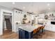 Well-equipped kitchen with a large center island, white cabinetry, and modern appliances at 107 Crescent Hill Ln, Rougemont, NC 27572