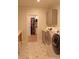 Functional laundry room equipped with a washer, dryer, cabinets, folding table, and walk in closet at 107 Crescent Hill Ln, Rougemont, NC 27572