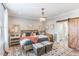 Beautiful main bedroom with a chandelier, barn door, and a view of the backyard at 107 Crescent Hill Ln, Rougemont, NC 27572