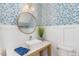 Modern powder room with designer wallpaper, marble countertop, and a vessel sink at 107 Crescent Hill Ln, Rougemont, NC 27572