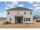 The back exterior view of the 2 story home featuring a screened-in porch at 1077 Kafka Dr, Fuquay Varina, NC 27526