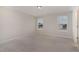 Cozy carpeted bedroom with two windows and natural light at 1077 Kafka Dr, Fuquay Varina, NC 27526