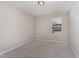 Bedroom with neutral walls, carpeted floor, and window view at 1077 Kafka Dr, Fuquay Varina, NC 27526