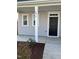 Front door to the light grey house, with the house number 1077 above the porch at 1077 Kafka Dr, Fuquay Varina, NC 27526