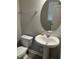 Powder room featuring a pedestal sink, oval mirror and neutral paint at 1077 Kafka Dr, Fuquay Varina, NC 27526