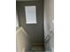 Carpeted stairs, leading down, illuminated by a window with bright light at 1077 Kafka Dr, Fuquay Varina, NC 27526