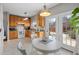 Bright kitchen with light wood cabinets, white appliances, and a round breakfast table at 10813 Laurnet Pl, Raleigh, NC 27614