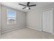 Inviting bedroom featuring a ceiling fan, neutral carpet, and a closet, complemented by natural light from the window at 1122 Briar Rose Ln, Durham, NC 27704