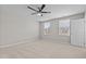 Spacious bedroom with neutral walls, carpeted floors, ceiling fan, and large windows at 1122 Briar Rose Ln, Durham, NC 27704