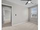 Comfortable bedroom featuring neutral carpet, natural light, and a view into the next room, creating a serene atmosphere at 1122 Briar Rose Ln, Durham, NC 27704