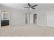 Bright, carpeted main bedroom features a ceiling fan, walk-in closet, and en-suite bathroom at 1122 Briar Rose Ln, Durham, NC 27704