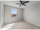 Welcoming bedroom features neutral carpet, natural light, and a ceiling fan, complemented by neutral colored walls at 1122 Briar Rose Ln, Durham, NC 27704
