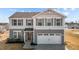 Charming two-story home with gray siding, blue shutters, and a two-car garage at 1122 Briar Rose Ln, Durham, NC 27704