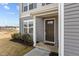 A close up of the front door to a charming gray two-story home at 1122 Briar Rose Ln, Durham, NC 27704