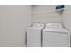 Efficient laundry area featuring a white washer and dryer, along with a wire shelf for storage solutions at 1122 Briar Rose Ln, Durham, NC 27704