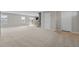 Open-concept living space with neutral carpet, open to a dining area and kitchen at 1122 Briar Rose Ln, Durham, NC 27704