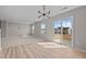 Bright living room features modern light fixture, neutral walls, and sliding glass doors to the backyard at 1122 Briar Rose Ln, Durham, NC 27704