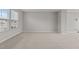 Spacious living room with neutral carpet and natural light from the window at 1122 Briar Rose Ln, Durham, NC 27704