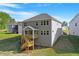 View of the backyard featuring a charming deck and stairwell, ideal for outdoor relaxation and entertainment at 124 Hemlock Falls Trl # 189, Raleigh, NC 27603