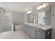Luxurious bathroom featuring a soaking tub, glass shower, double vanity, and ample lighting at 124 Hemlock Falls Trl # 189, Raleigh, NC 27603